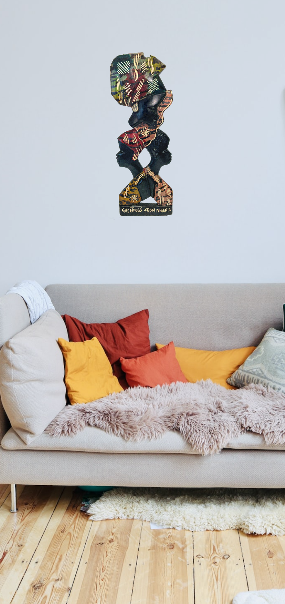 A Nigerian Carved Wall Art - African Unity on a wall in a room