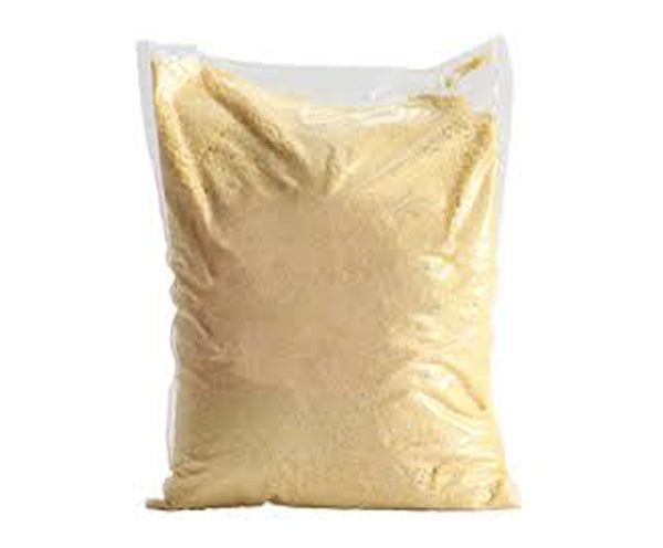 Yellow Garri in a white polyethene bag.